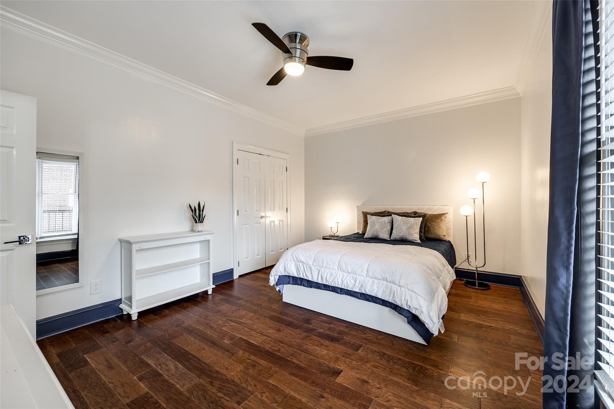 325 Queens Road Charlotte, NC 28204 - Photo 8 of 33 a bedroom with a bed and a ceiling fan