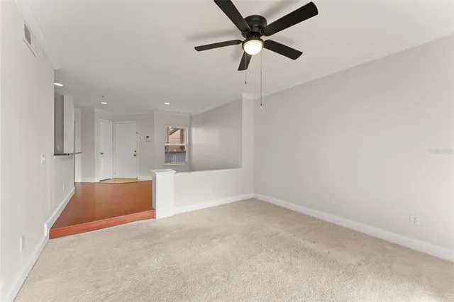 en empty room with kitchen view and window