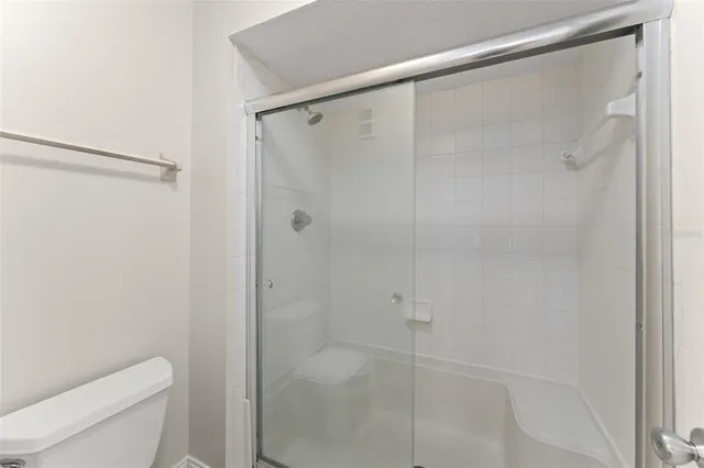 a bathroom with a shower and a toilet