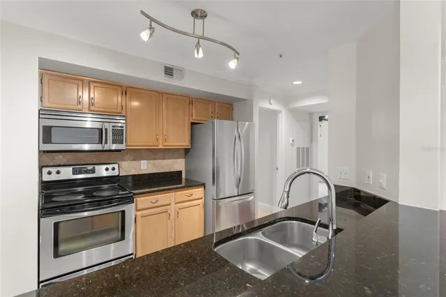 a kitchen with granite countertop a stove and a sink