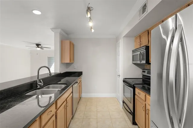a kitchen with stainless steel appliances granite countertop a sink stove and refrigerator