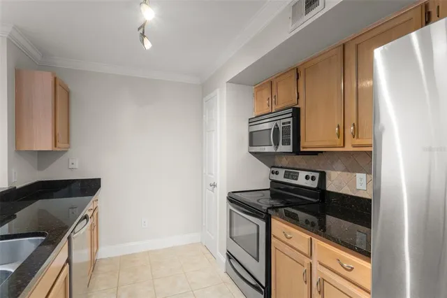 a kitchen with stainless steel appliances granite countertop a stove and a refrigerator