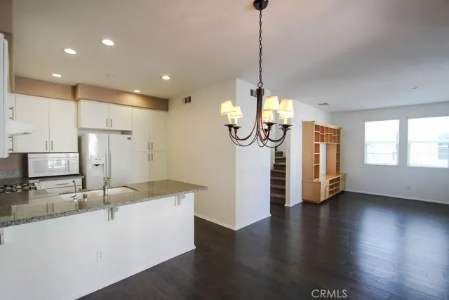 a view of a kitchen with a sink appliances and a ceiling fan