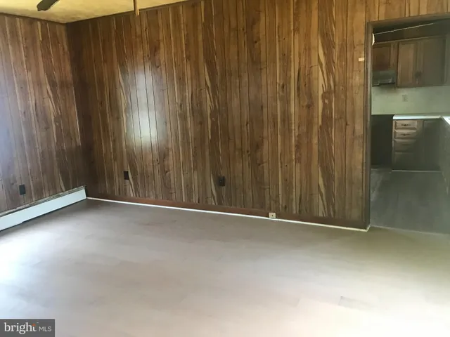 a view of an empty room with wooden walls