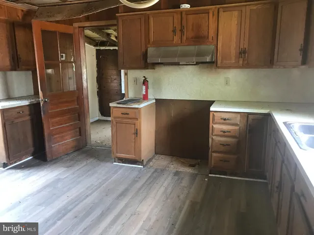 a kitchen with granite countertop a refrigerator and a stove