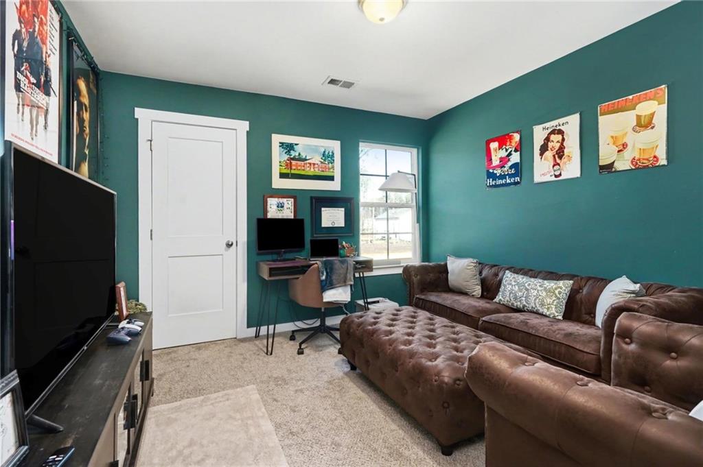 31 Breckens Way Statham, GA 30666 - Photo 12 of 24 a living room with furniture and a flat screen tv