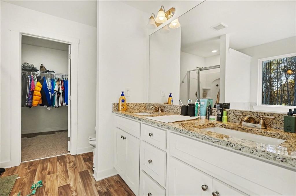 31 Breckens Way Statham, GA 30666 - Photo 15 of 24 a bathroom with a granite countertop sink and a mirror