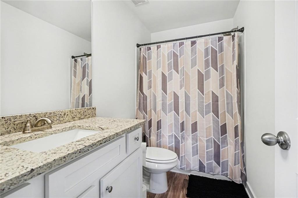 31 Breckens Way Statham, GA 30666 - Photo 21 of 24 a bathroom with a granite countertop sink and a mirror