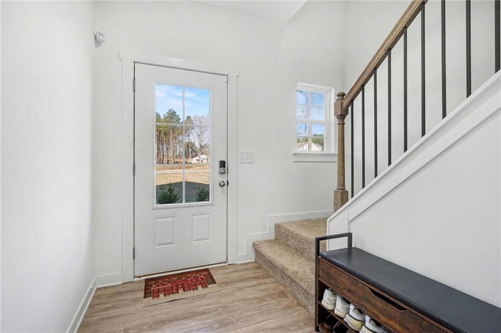 31 Breckens Way Statham, GA 30666 - Photo 5 of 24 a view of front door with wooden floor and stairs