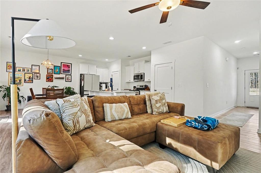 31 Breckens Way Statham, GA 30666 - Photo 6 of 24 a living room with furniture kitchen view and a chandelier