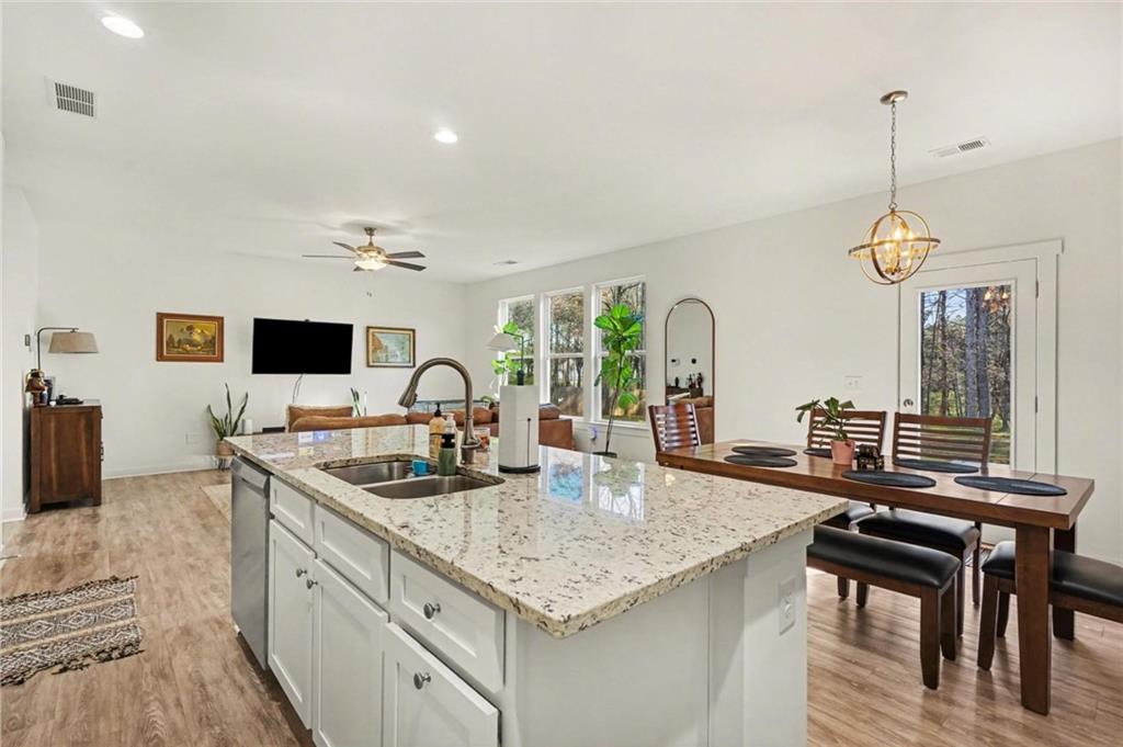 31 Breckens Way Statham, GA 30666 - Photo 8 of 24 a kitchen with stainless steel appliances granite countertop a sink and a stove