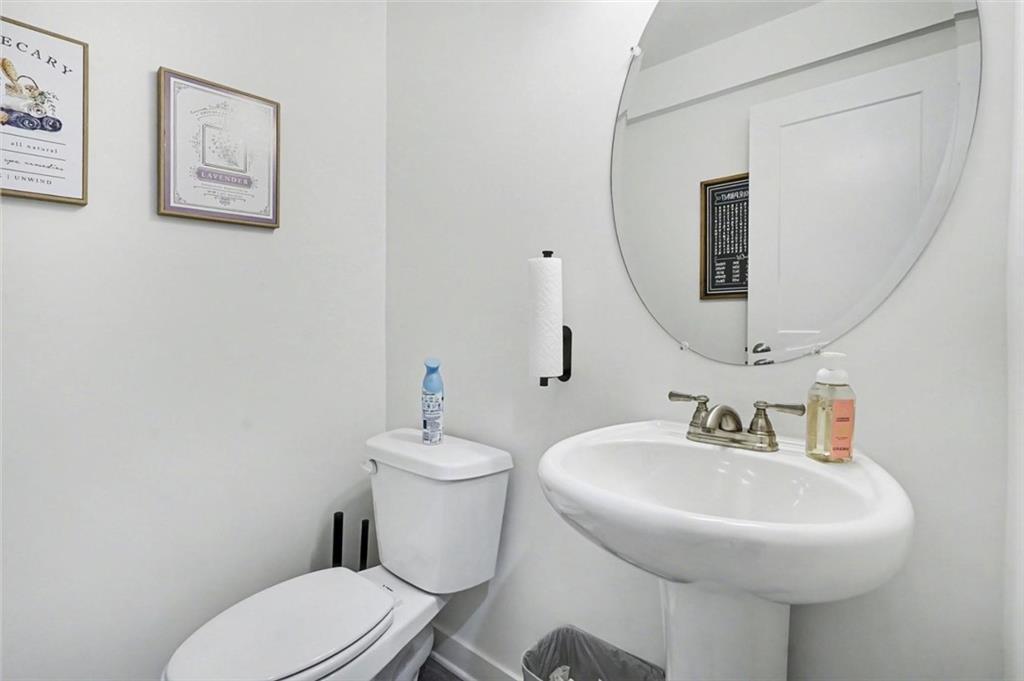 31 Breckens Way Statham, GA 30666 - Photo 10 of 24 a bathroom with a toilet a sink and mirror