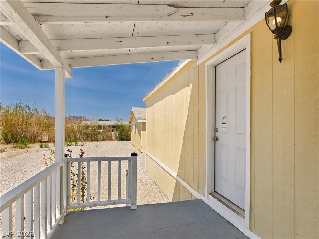 4081 Retread Road Pahrump, NV 89048 - Photo 54 of 98 A welcoming front porch with simple railing leads to the home's main entry.