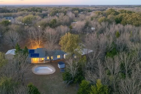 an aerial view of a house with pool