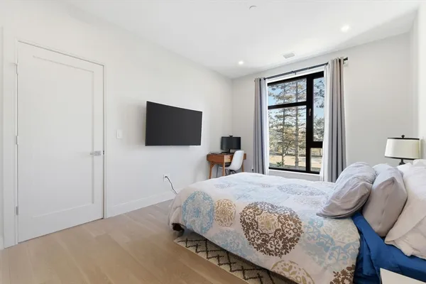 a bedroom with a bed and a flat screen tv