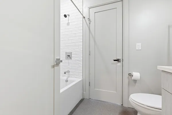 a bathroom with a toilet a sink and a shower