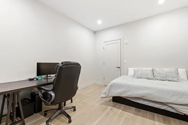 a bedroom with a workspace