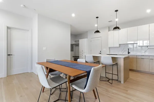a view of a dining room with furniture and wooden floor