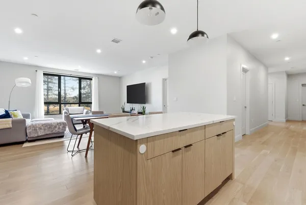 a view of a kitchen with a sink and wooden floor