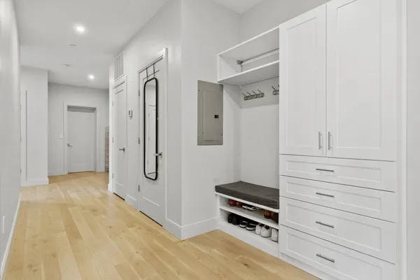 a large bed sitting in a bedroom next to a window with a flat tv screen and dresser