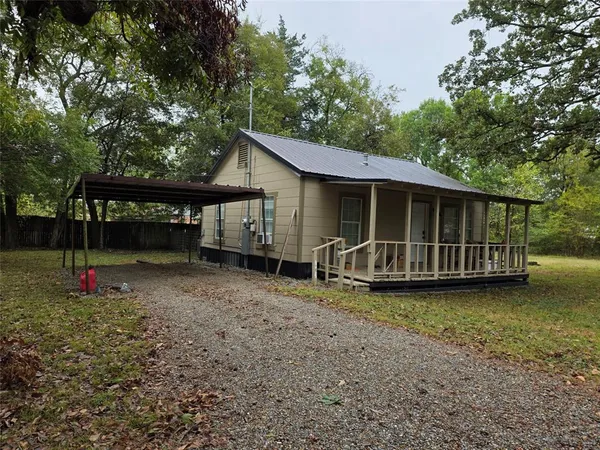 a view of a house with a yard and sitting area