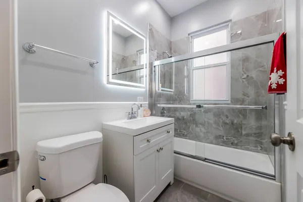 a bathroom with a sink a toilet and shower