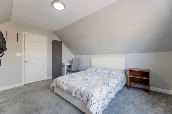 a bedroom with a bed and a desk