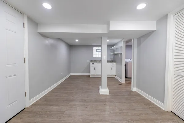 wooden floor in an empty room with a kitchen