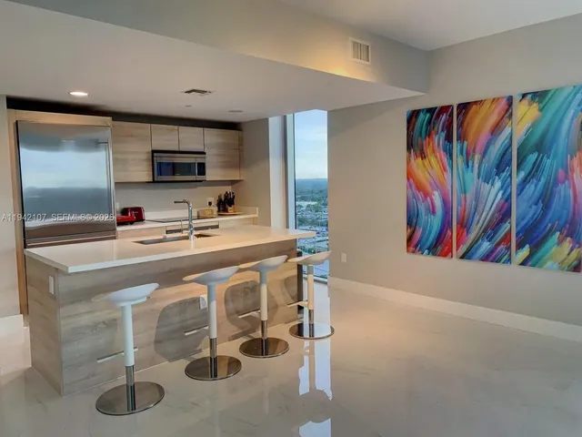 a kitchen with stainless steel appliances a microwave and cabinets