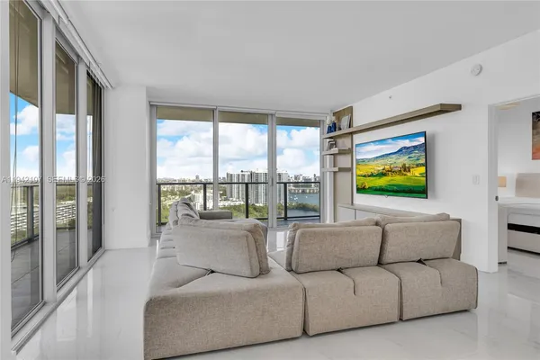 a living room with furniture and large window