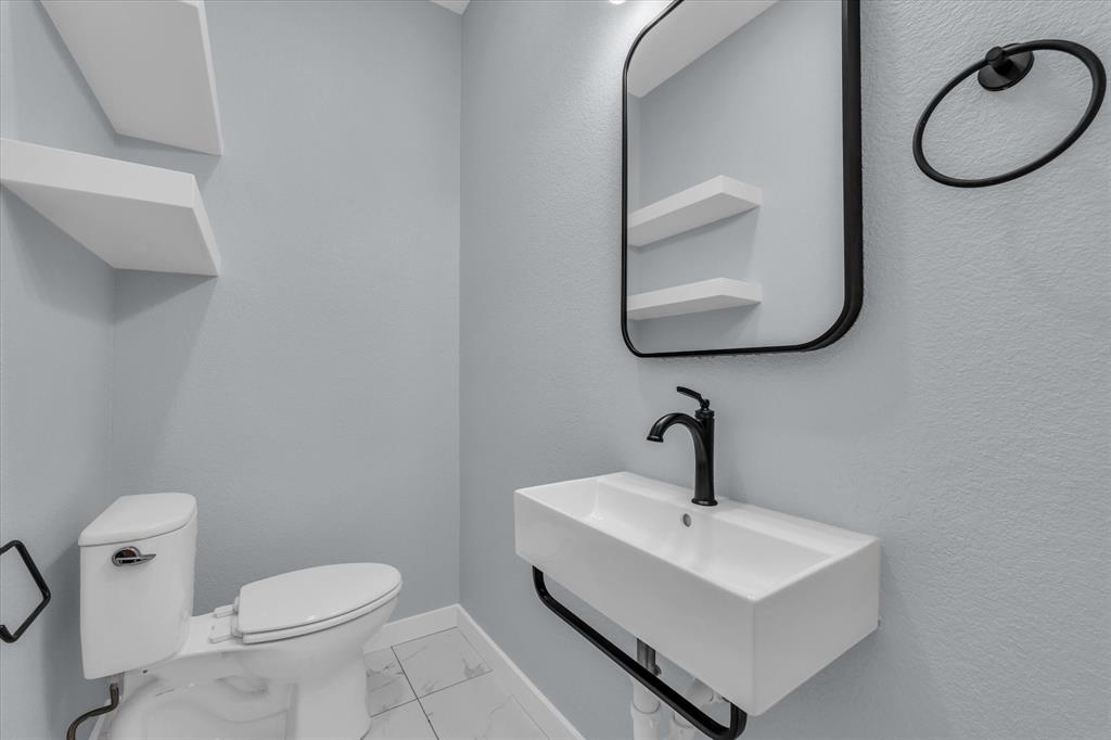 308 Crye Circle Robinson, TX 76706 - Photo 15 of 37 a bathroom with a sink a toilet and mirror