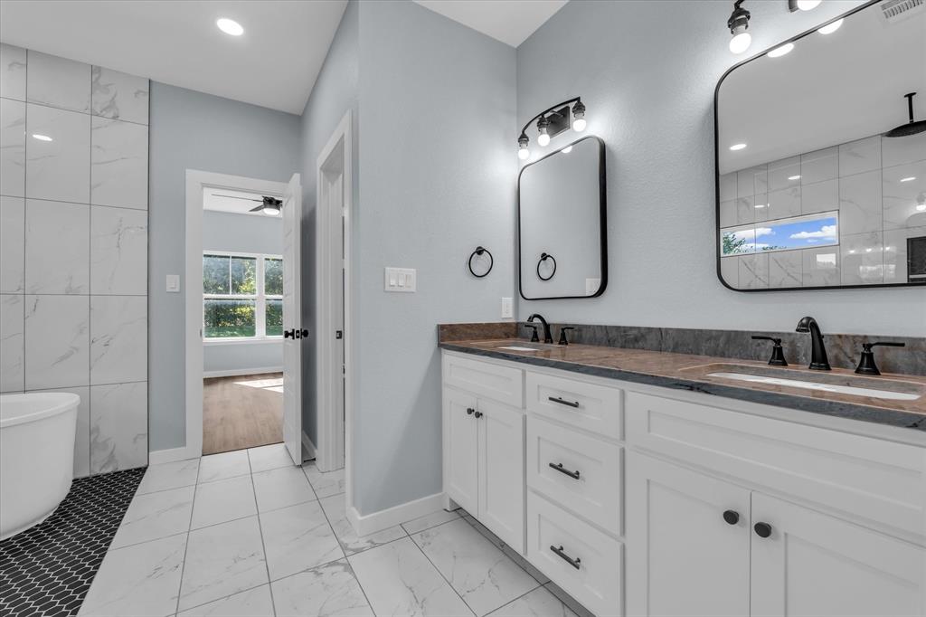 308 Crye Circle Robinson, TX 76706 - Photo 20 of 37 a spacious bathroom with a granite countertop sink a toilet and a mirror