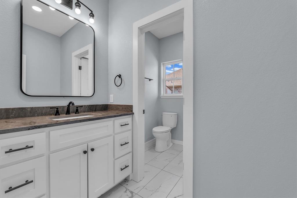 308 Crye Circle Robinson, TX 76706 - Photo 23 of 37 a bathroom with a granite countertop sink mirror and toilet