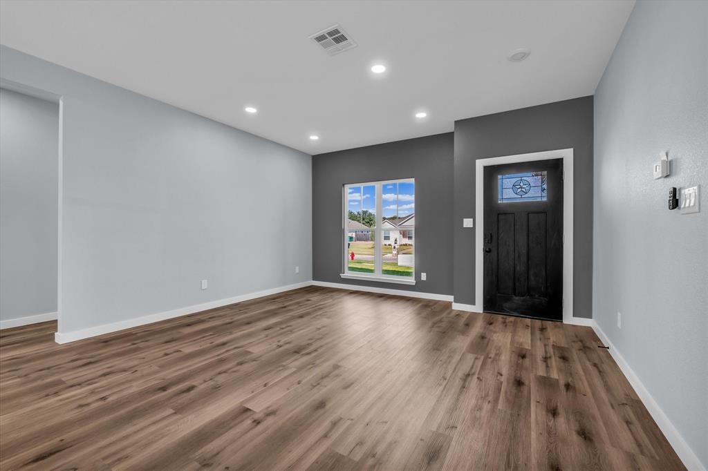 308 Crye Circle Robinson, TX 76706 - Photo 5 of 37 a view of an empty room with wooden floor and window