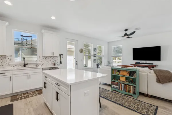 a kitchen with white cabinets and stainless steel appliances
