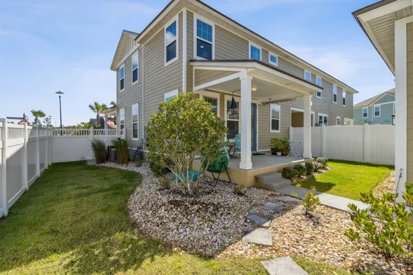 a view of a swimming pool with outdoor seating and plants