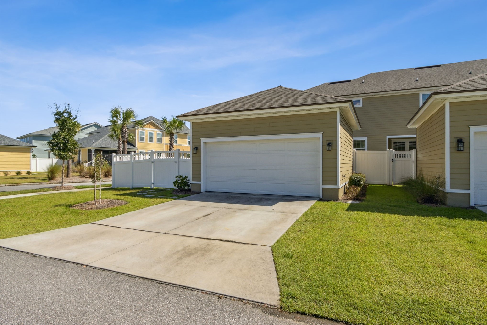 213 Daydream Avenue Yulee, FL 32097 - Photo 32 of 40 a front view of a house with a yard and garage