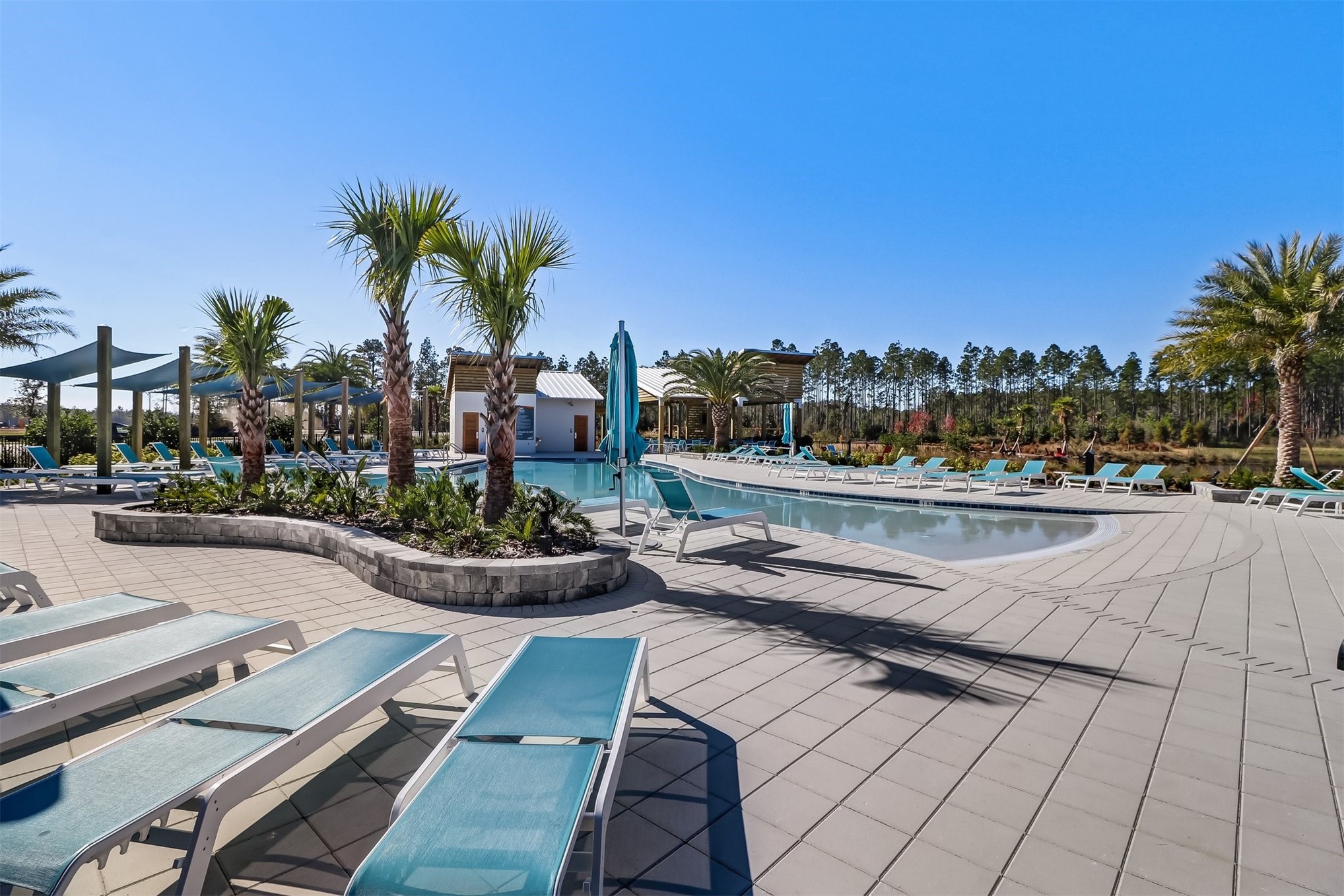 213 Daydream Avenue Yulee, FL 32097 - Photo 33 of 40 a view of a swimming pool with outdoor seating and plants