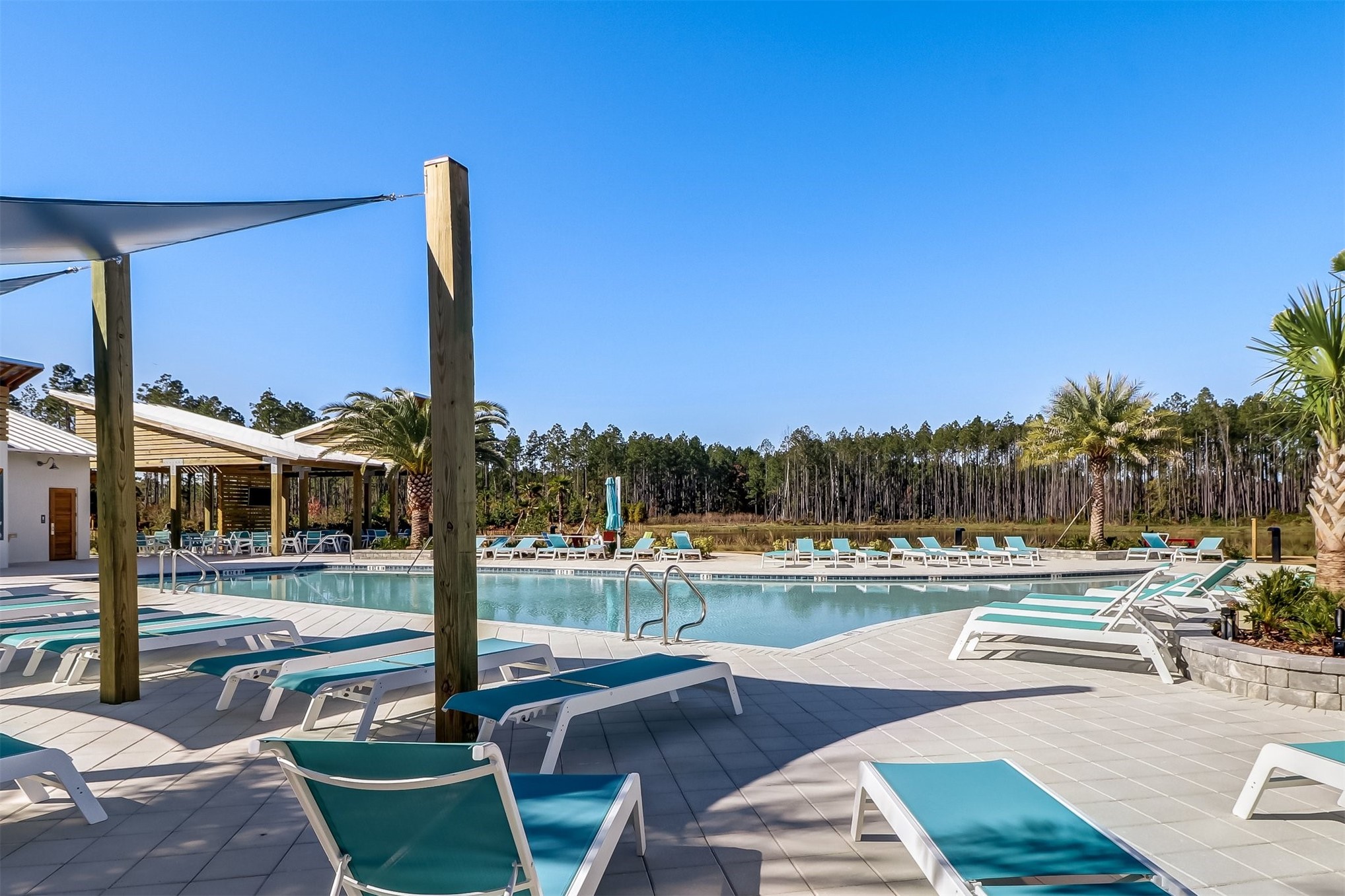 213 Daydream Avenue Yulee, FL 32097 - Photo 34 of 40 a view of a swimming pool with lawn chairs