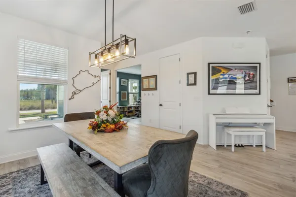 a living room with furniture kitchen view and a window