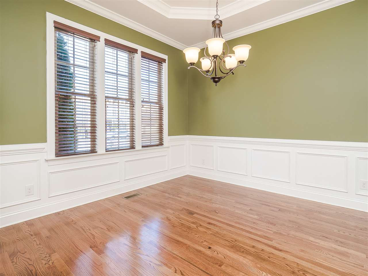3004 Royal Forrest Drive Raleigh, NC 27614 - Photo 4 of 25 Savor Christmas and Thanksgiving meals in your new formal dining room. Large windows provide lots of natural light. Detail moulding throughout with chair rail, Wainscot, trey ceiling, crown moulding. Beautiful chandelier and gleaming hardwoods. Dining Room