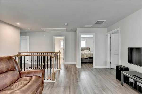 a bedroom with furniture and a wooden floor
