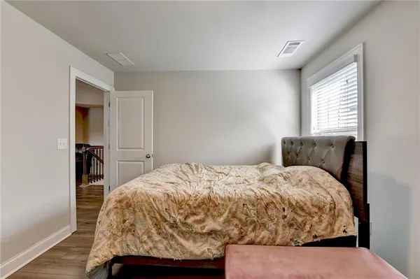 a bed sitting in a bedroom next to a window