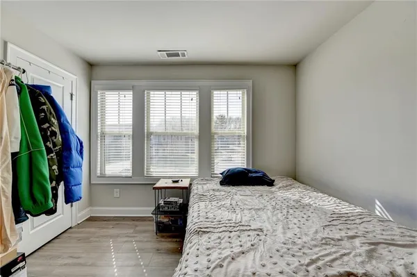 a bedroom with a bed and a large window