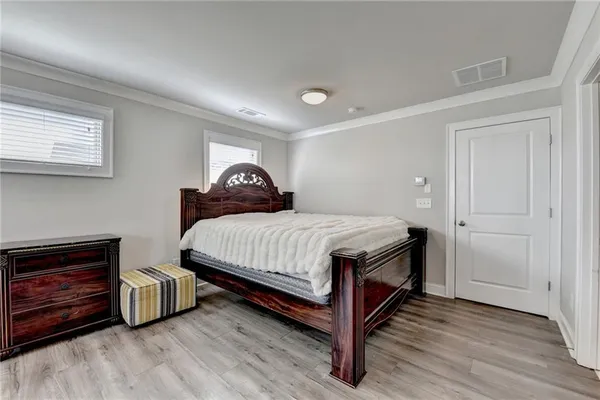 a bedroom with a bed and a dresser