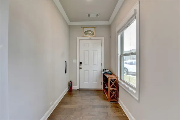 a view of an entryway with wooden floor