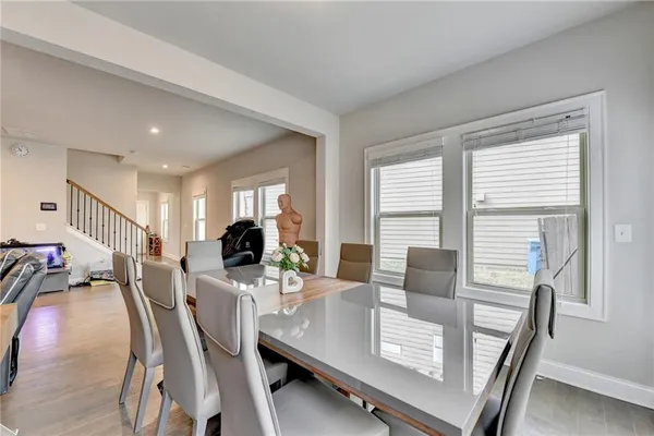 a view of a dining room with furniture and a potted plant