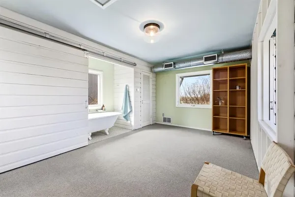 an empty room with windows and closet