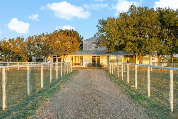 a view of house with outdoor space and trees