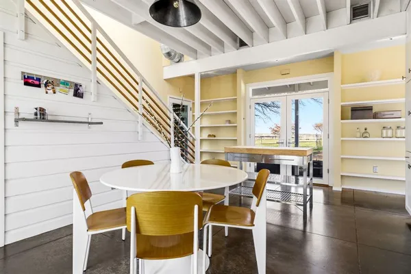 a dining room with furniture and wooden floor